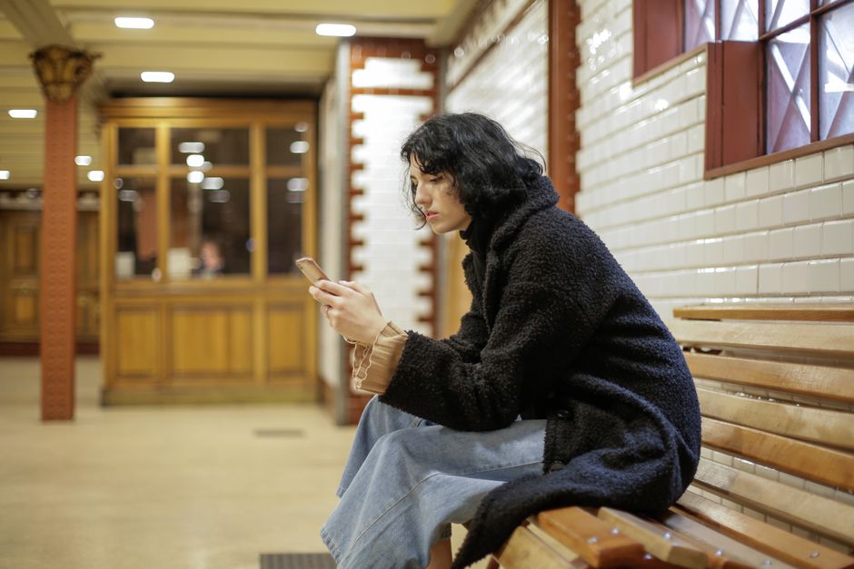 A person using a mobile phone, waiting for content to load